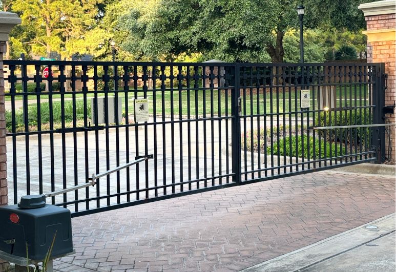 Custom automatic steel driveway gate installation at a residential property in Austin, Texas featuring electronic gate operators and secure access control.