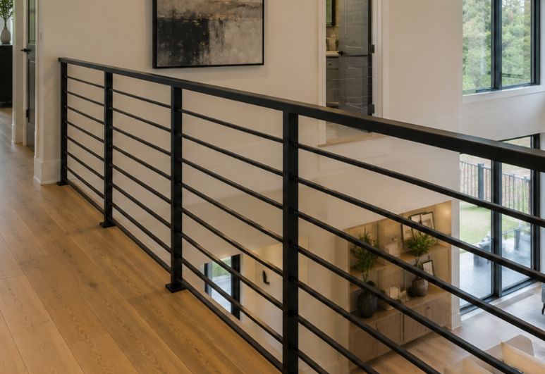 Custom black steel railing installed in a residential property in Austin, Texas featuring modern welded metal craftsmanship and clean architectural design.