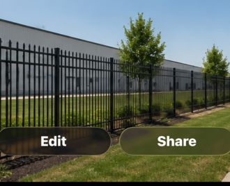 Heavy-duty steel perimeter fence installed around a warehouse and industrial facility in Austin, Texas for security and controlled access.