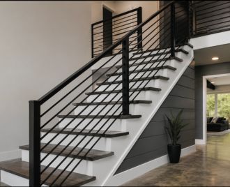 Custom black steel stair railing and banister installed inside a modern home in Austin, Texas featuring welded steel construction and contemporary design.