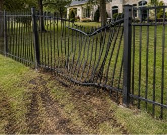 Leaning steel fence post being repaired and reinforced by a professional welder in Austin, Texas to restore fence stability and alignment.
