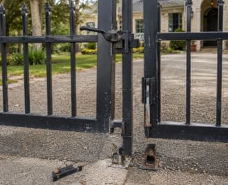 Damaged steel gate latch and drop rod being repaired on a metal gate in Austin, Texas to restore secure closure and proper operation.