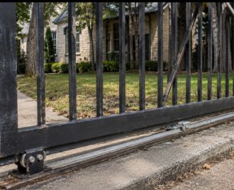 Commercial cantilever gate track and roller system being repaired in Austin, Texas to restore smooth gate operation and secure property access.