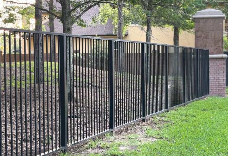 Custom black steel fence installed at a residential property in Austin, Texas showcasing professional craftsmanship and durable welded construction.