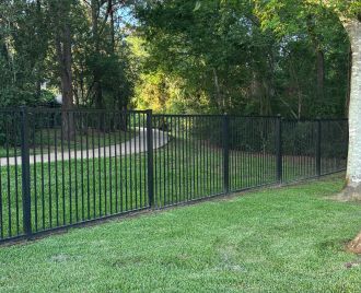 Modern black steel fence installed around a residential property in Austin, Texas showcasing clean lines and professional fabrication.