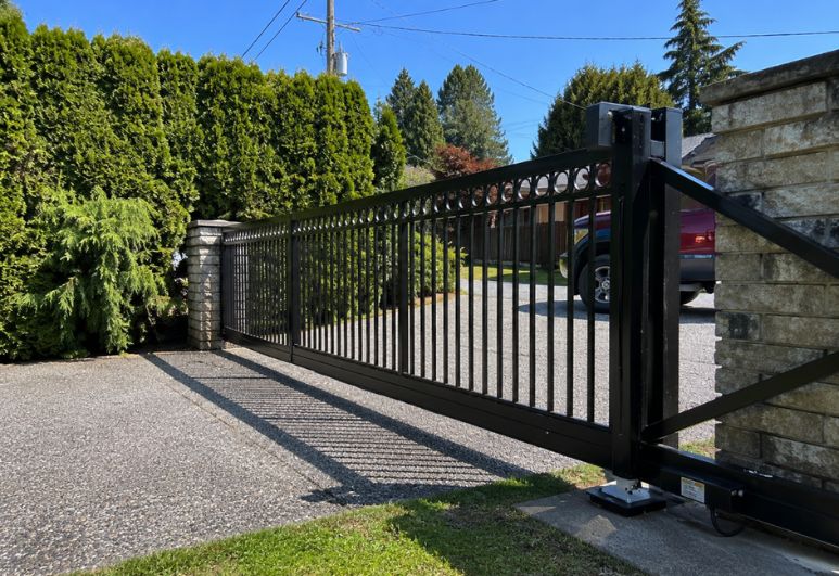 Custom residential cantilever steel gate installed at a home in Austin, Texas for secure driveway access.