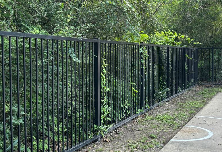 Custom steel privacy fence installed around a residential property in Austin, Texas.